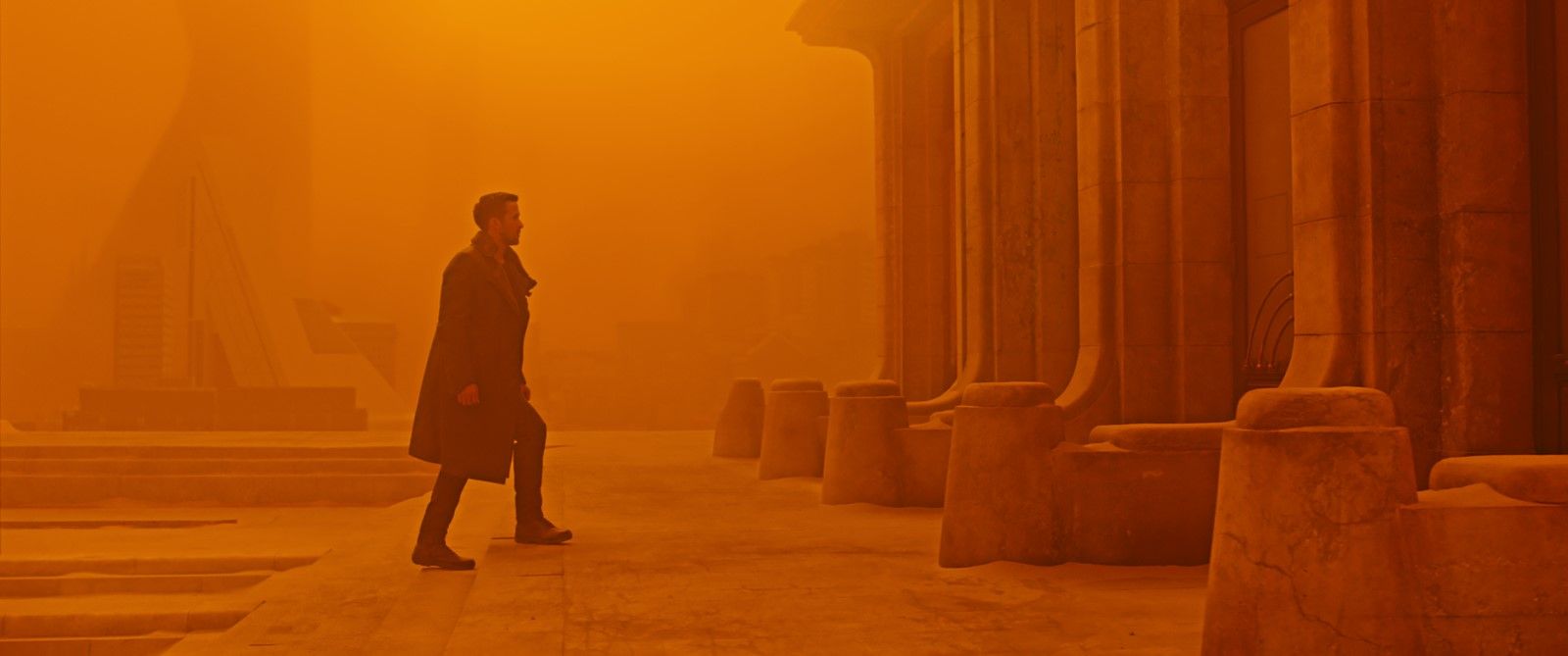 Ryan Gosling walking through the orange haze of Las Vegas in Blade Runner 2049
